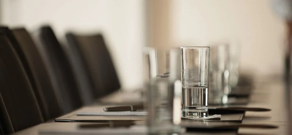 Water glasses on a conference room table