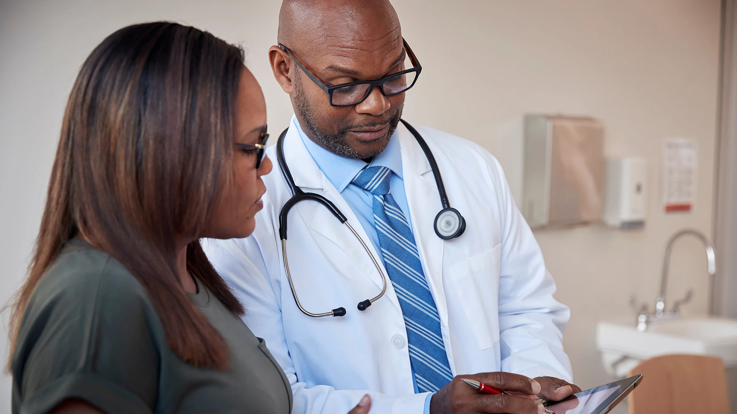 A doctor and patient looking at a tablet